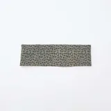 Diadema de tela color verde militar con estampado de leopardo en negro y blanco.