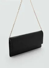 Bolso de mano negro de piel con asa corta de cadena y asa de hombro. Tiene cierre de solapa con botón magnético, tamaño mediano, diseño rectangular y forro interior.