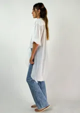 Camisa blanca de algodón con mangas 3/4 abullonadas y cuello mao. Se ata en la parte delantera.