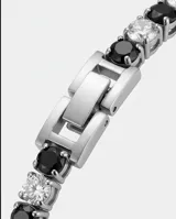 Pulsera de acero inoxidable con diseño de tenis, compuesta por una hilera de circonias blancas y negras alternadas. Cuenta con cierre de seguridad.