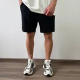 Short de algodón color beige melange, de diseño cómodo y holgado con bolsillos laterales y terminación descosida en las perneras.