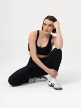 Calza deportiva de tiro alto en color negro, confeccionada en tejido elástico y ajustado que brinda soporte y libertad de movimiento.