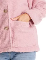 Sobrecamisa de tejido sherpa color blanco, con cuello solapa, cierre frontal con botones y bolsillos delanteros.