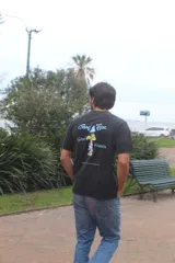 Remera negra de algodón 100% peinado, de corte recto y manga corta, con estampado gráfico trasero en colores celeste y amarillo con la inscripción 'Good Trips, Good Friends'.