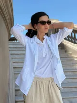Blazer blanco de lino con solapas y bolsillos frontales.