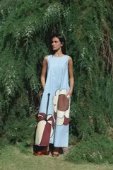 Vestido largo sin mangas de corte holgado, con cuello redondo y bolsillos laterales. Confeccionado en algodón, presenta un diseño minimalista y fluido.