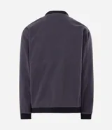 Campera deportiva reversible de manga larga con cierre frontal de cremallera, cuello alto y bolsillos laterales. Confeccionada en poliamida con forro interior de fleece, presenta un pequeño logo estampado en el pecho.