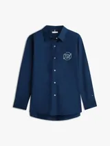 Camisa de Tommy Hilfiger azul marino, de manga larga con diseño ajustable tipo roll-tab, cuello camisero, cierre frontal con botones y logo gráfico bordado en el pecho.