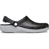 Zuecos deportivos Crocs Classic Clog Turbo, color negro con suela gris, correa trasera ajustable con detalles reflectantes y suela de goma para mayor tracción.
