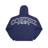 Buzo con capucha azul marino de corte holgado, con estampado gráfico en blanco en la espalda que incluye la palabra Corteiz y una cinta con la frase Regne Sur Le Monde.