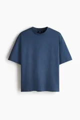 Remera de punto de algodón con corte oversized, cuello redondo acanalado y diseño de hombros caídos.