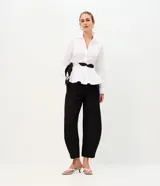 Pantalón de sastrería con modelado barrel, de corte amplio en las piernas y cintura estructurada. Confeccionado en tejido crepe, cuenta con cierre oculto y presillas para cinturón.