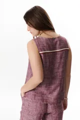 Top sin mangas de corte recto y holgado, confeccionado en tejido de lino con textura jaspeada en tono azul. Presenta cuello redondo y un diseño minimalista ideal para climas cálidos.