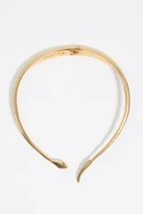 Collar rígido tipo gargantilla de la marca Bimba y Lola, con diseño en forma de serpiente. Presenta un acabado metálico dorado con textura de escamas en los extremos y cierre de bisagra en la parte posterior.