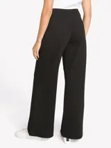 Pantalón negro de tiro alto Tommy Hilfiger de pernera ancha, con detalles de tres botones dorados en los laterales y cierre frontal.