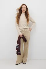 Pantalon de corte recto y tiro alto, confeccionado en un tejido de acabado suave y textura aterciopelada, con costuras verticales decorativas en el frente.