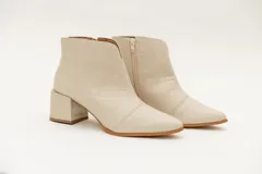 Botín de cuero color crema con textura croco, punta fina y taco cuadrado.