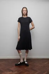 Vestido midi negro confeccionado en viscosa, de corte evasé, mangas cortas y escote redondo.
