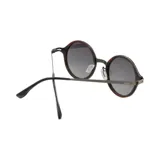 Lentes de sol Indie Wilco con montura redonda de madera color marrón y metal plateado, y lentes grises degradadas.
