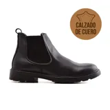 Bota Chelsea de cuero negro, con elásticos laterales y suela de goma.