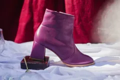 Botín de cuero color violeta con cierre lateral, taco cuadrado y punta redondeada. Forro, capellada y plantilla 100% cuero.