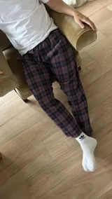 Pantalón de hombre confeccionado en franela a cuadros grises y marrones, con elástico en la cintura y dos bolsillos laterales.