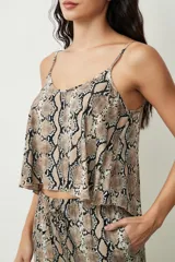 Conjunto de top y short con estampado de piel de serpiente en tonos beige y negro. El top es de tirantes finos y corte holgado. El short es de corte holgado con cintura elástica ajustable.
