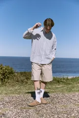 Short color beige de tiro medio con cierre de cremallera, bolsillos delanteros y traseros.