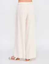 Pantalón palazzo color blanco, confeccionado en mezcla de lino y viscosa, de tiro alto con cierre frontal de botones, pinzas en la cintura y piernas anchas.