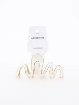 Pinza para el pelo con diseño de ondas, acabado en color blanco con bordes metálicos dorados.