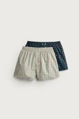 Pack de dos calzoncillos tipo bóxer de popelina de algodón con cintura elástica. Uno con diseño a cuadros multicolor y otro de fondo azul marino con estampado de pequeños balones.