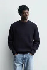 Jersey de punto con corte regular fit, cuello redondo y manga larga. Presenta un diseño de textura acanalada con acabados en rib en puños y bajo.