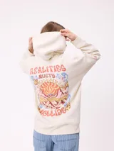 Canguro color crema con capucha y estampado grande en la espalda de un sol con un ojo, montañas, mariposas y texto.