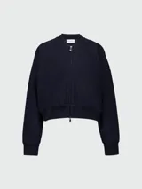 Chaqueta tipo bomber de Moncler, color azul marino, con cierre frontal de cremallera, cuello redondo y puños elásticos.