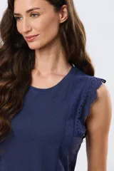 Musculosa de algodón color azul con detalles de broderie calado en los hombros, de cuello redondo y corte clásico.