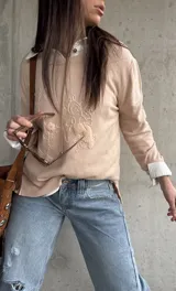 Sweater Carli de tejido de punto en color beige, de manga larga y con delicados bordados florales en relieve en el frente.