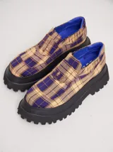 Mocasines color marrón con estampado de cocodrilo y plataforma negra con suela dentada.