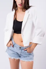 Blazer negro de corte estructurado, con solapas de muesca, manga larga con puños doblados y bolsillos frontales.