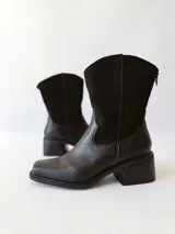 Botas texanas de cuero negro con caña media, puntera cuadrada y tacón bloque.