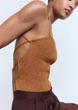 Top de punto con acabado de lúrex en color bronce, de diseño entallado, cuello escotado y tirantes finos que se cruzan en la espalda.