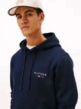 Buzo con capucha y bolsillo canguro Tommy Hilfiger de color azul marino, con cordones ajustables, puños y bajo acanalados, y pequeño logo bordado en el pecho.