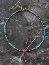 Gargantilla de cuentas de apatita, turquesa y granate con separadores en oro laminado 14k y dije de turmalina engarzada en plata 925 con baño de oro 18k.