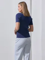 Buzo azul de tejido acanalado, con escote cuadrado y aplique de botones.