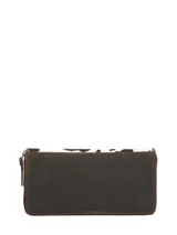 Billetera Rockford de cuero natural con pelo de vaca, diseño con estampa animal print de vaca en color blanco y negro, con detalles en marrón y cierre perimetral.