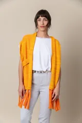Chaleco artesanal de hilo color naranja con presilla para sujetarlo y terminación en flecos.