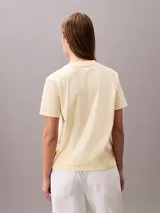 Remera Calvin Klein Jeans de manga corta y cuello redondo, color amarillo claro, con el logo de la marca estampado en el pecho en tono blanco.