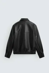 Cazadora bomber de efecto piel color marrón oscuro, con cuello solapa, cierre frontal de cremallera, bolsillos de vivo en cadera y bajo elástico.