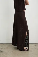 Falda larga tejida de punto en algodón color blanco, con diseño calado de patrones abstractos y orgánicos.