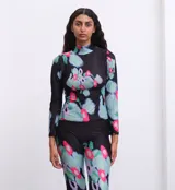 Polera de cuello alto y mangas largas, confeccionada en tela sublimada con estampado abstracto en tonos negro, verde, azul y rosa.