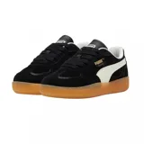 Championes Puma Palermo de gamuza negra con franja lateral blanca y suela de goma color caramelo.